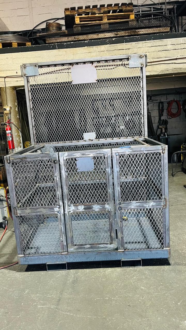 Fabricated metal mesh enclosure with hinged front panels in the workshop